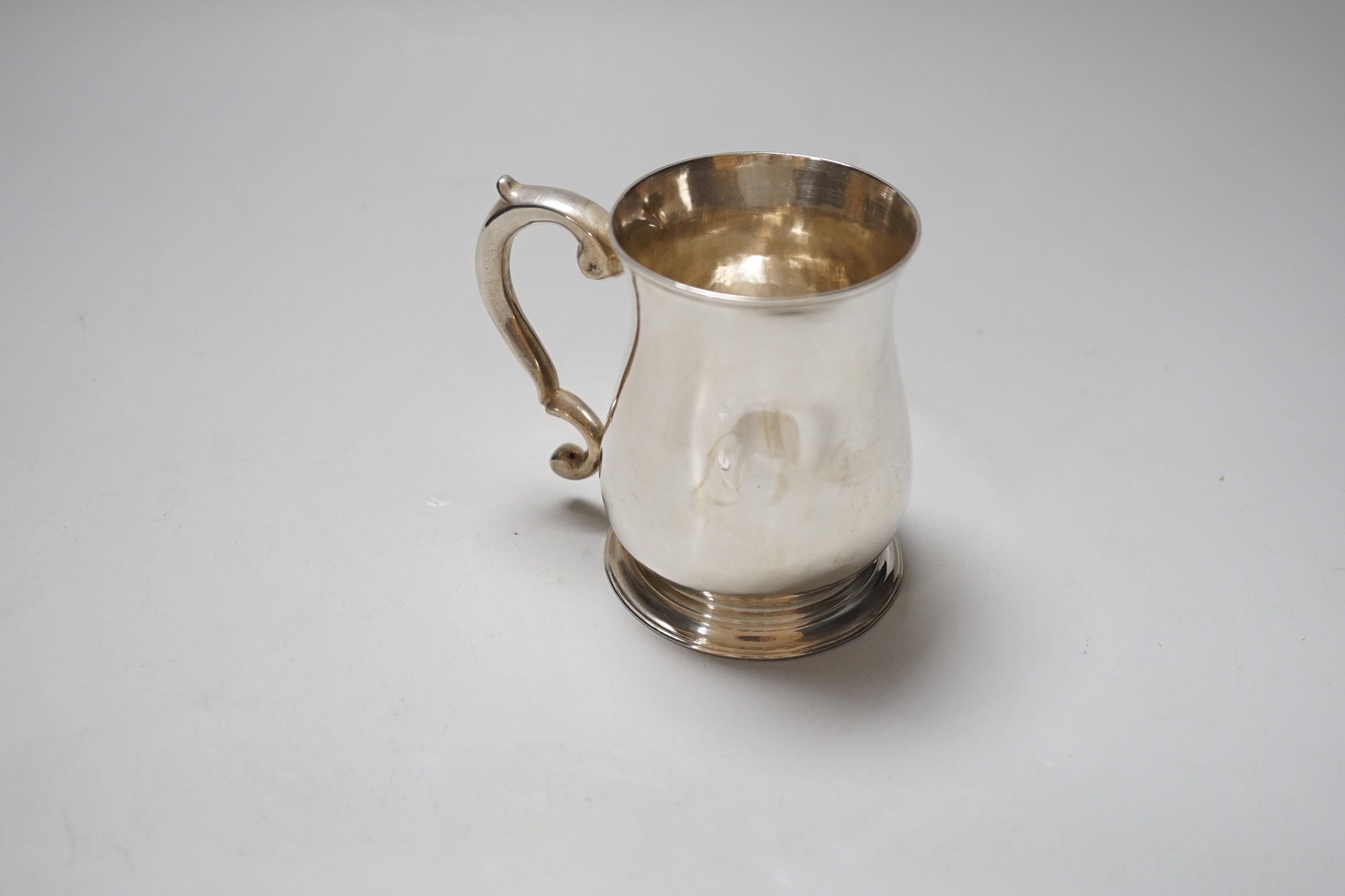 A George II silver baluster mug with scroll handle, makers mark rubbed, London 1752, 9cm, 160 grams